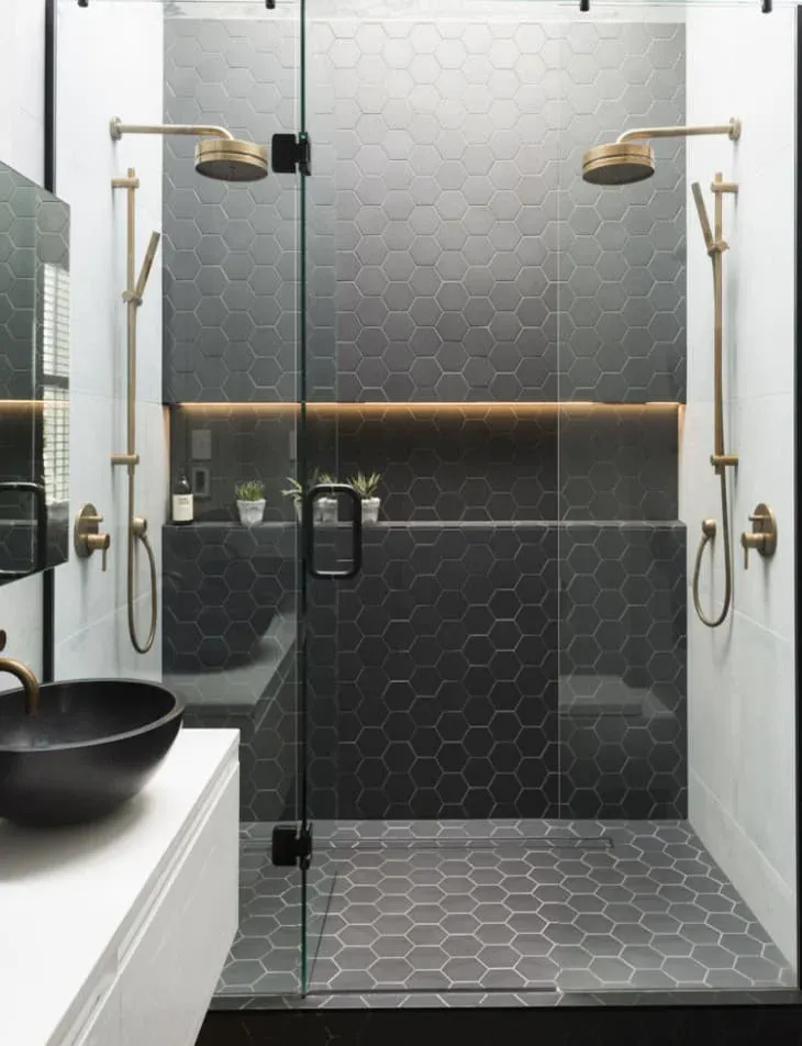 Frameless glass shower enclosure in a finished bathroom
