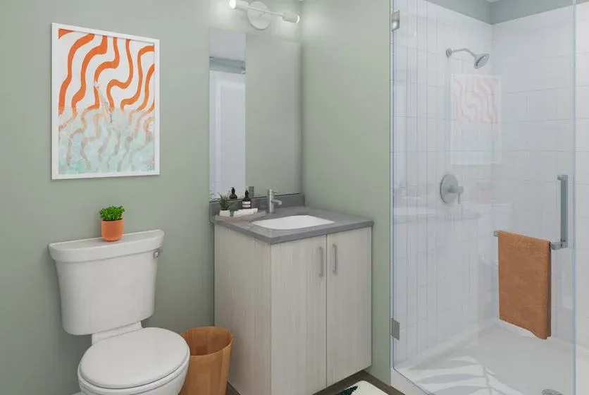 Glass shower enclosure in a student-housing bathroom